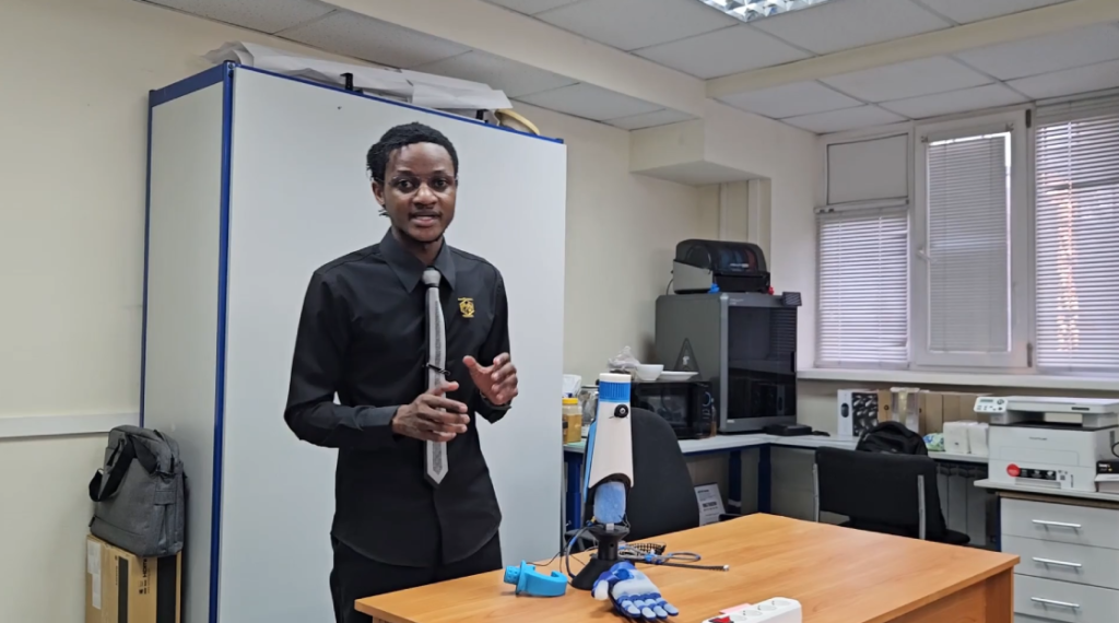 Fiel Nghikofa presenting a prosthetic arm prototype